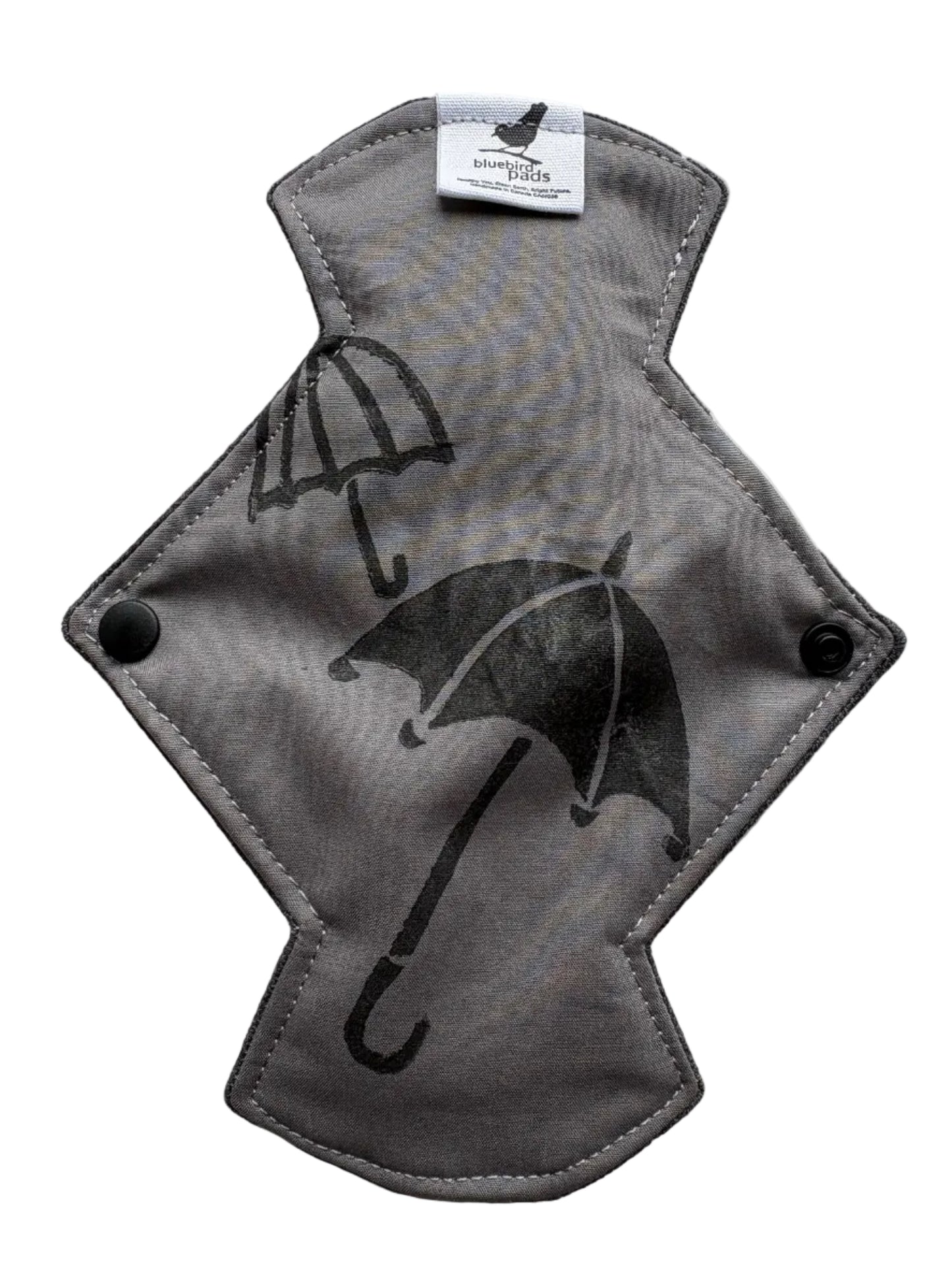 Gray pad with black umbrella stamp on it