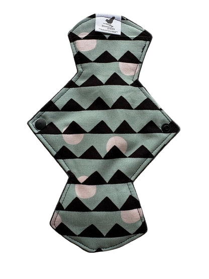 Reusable menstrual pad with geometric pattern on a light gray background