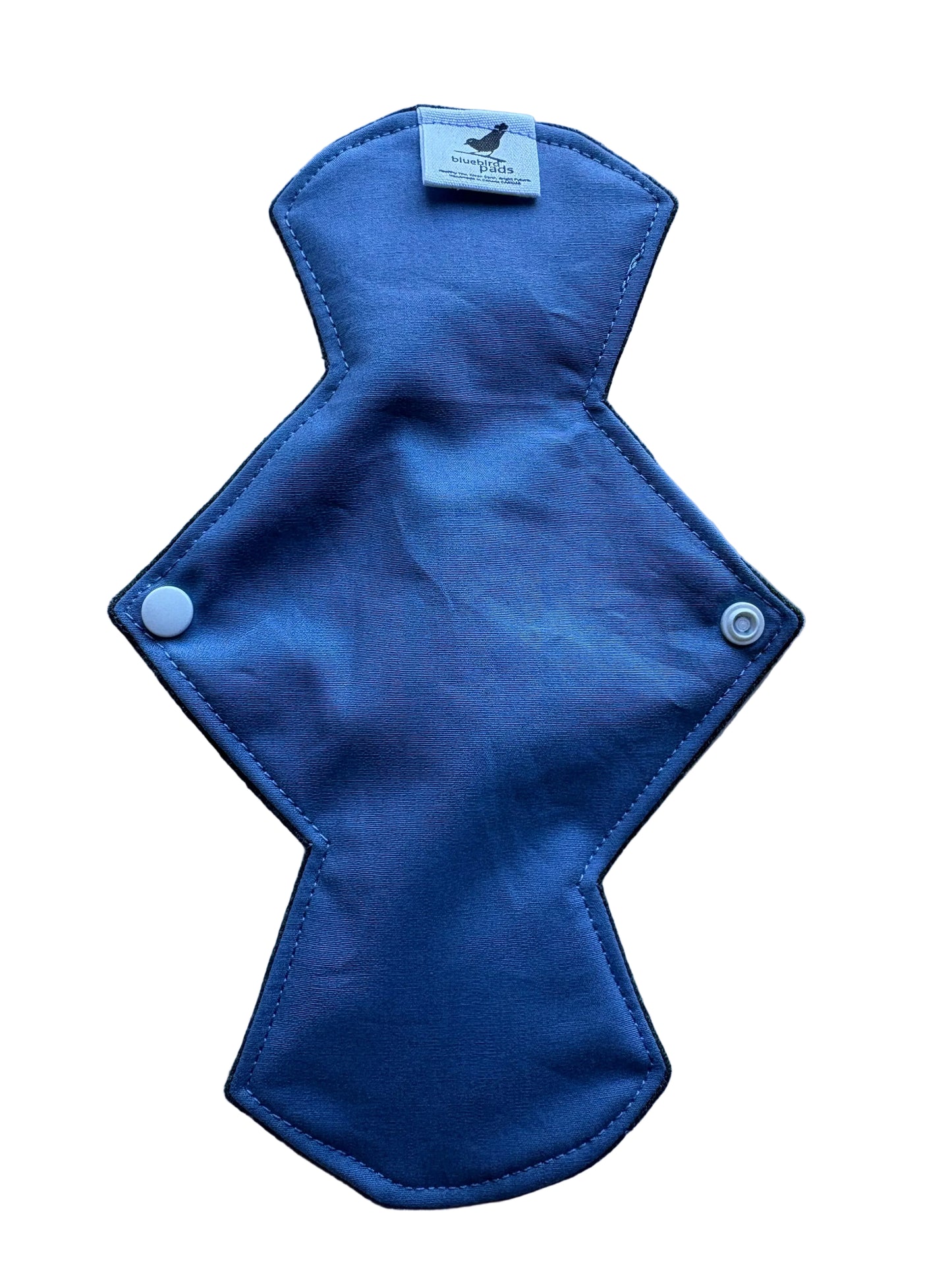 Blue cloth pad with a tag on a light blue background