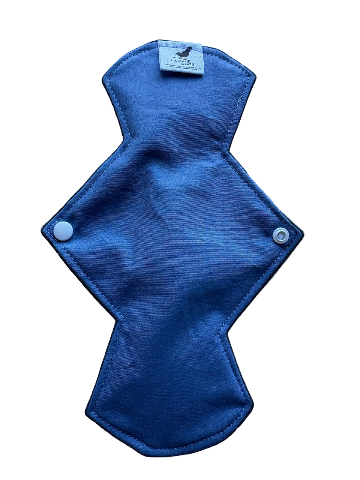 Blue cloth pad with a tag on a light blue background