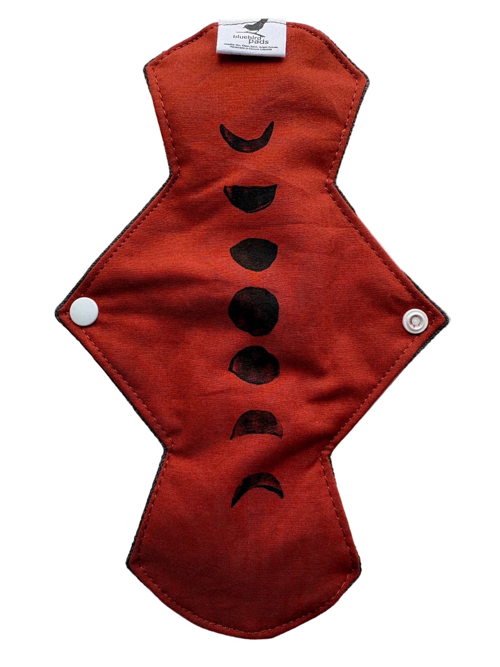 Brick Orange cloth pad with black phases of the moon stamp design 