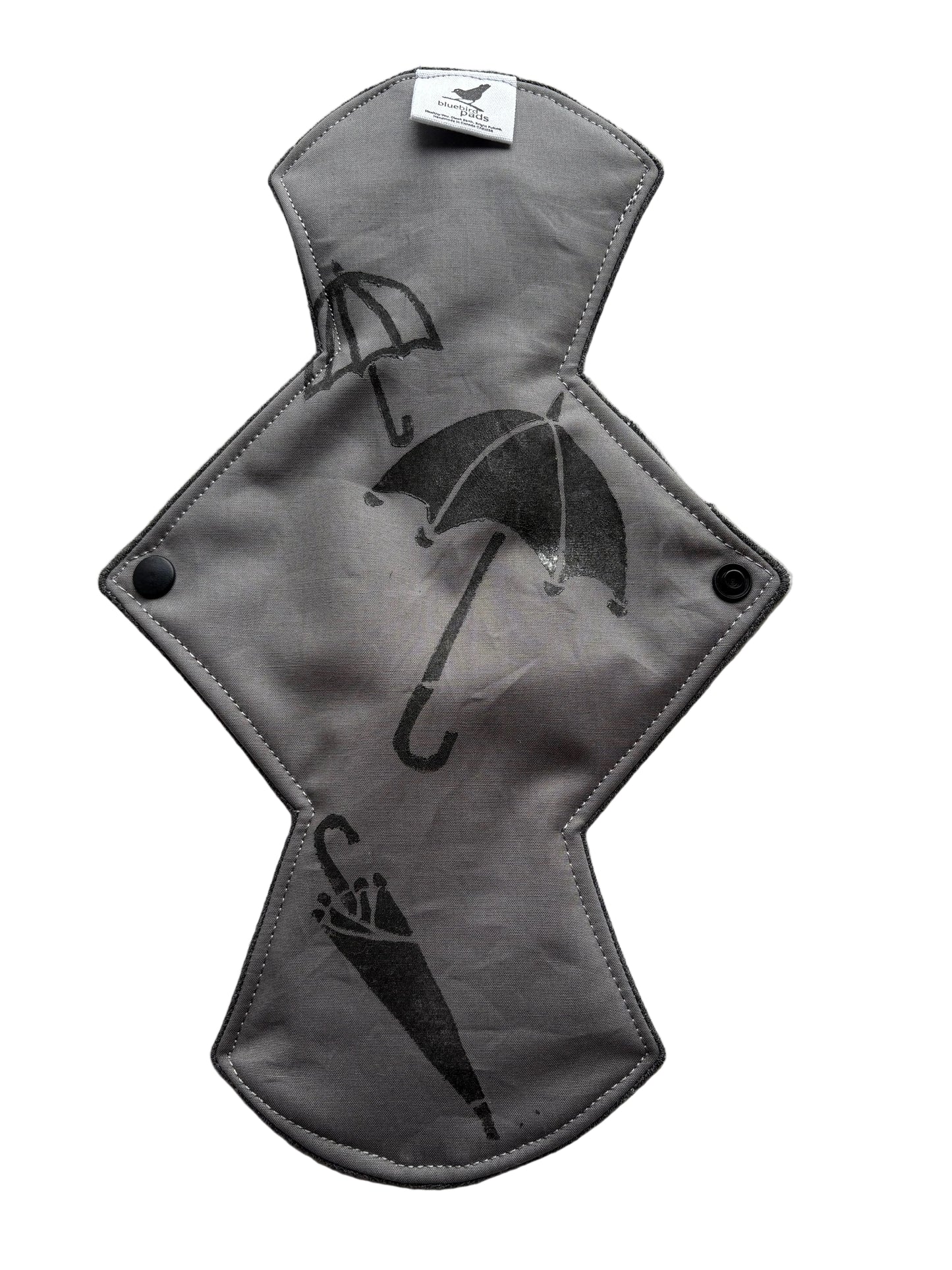 Gray sanitary pad with black umbrella stamp pattern 