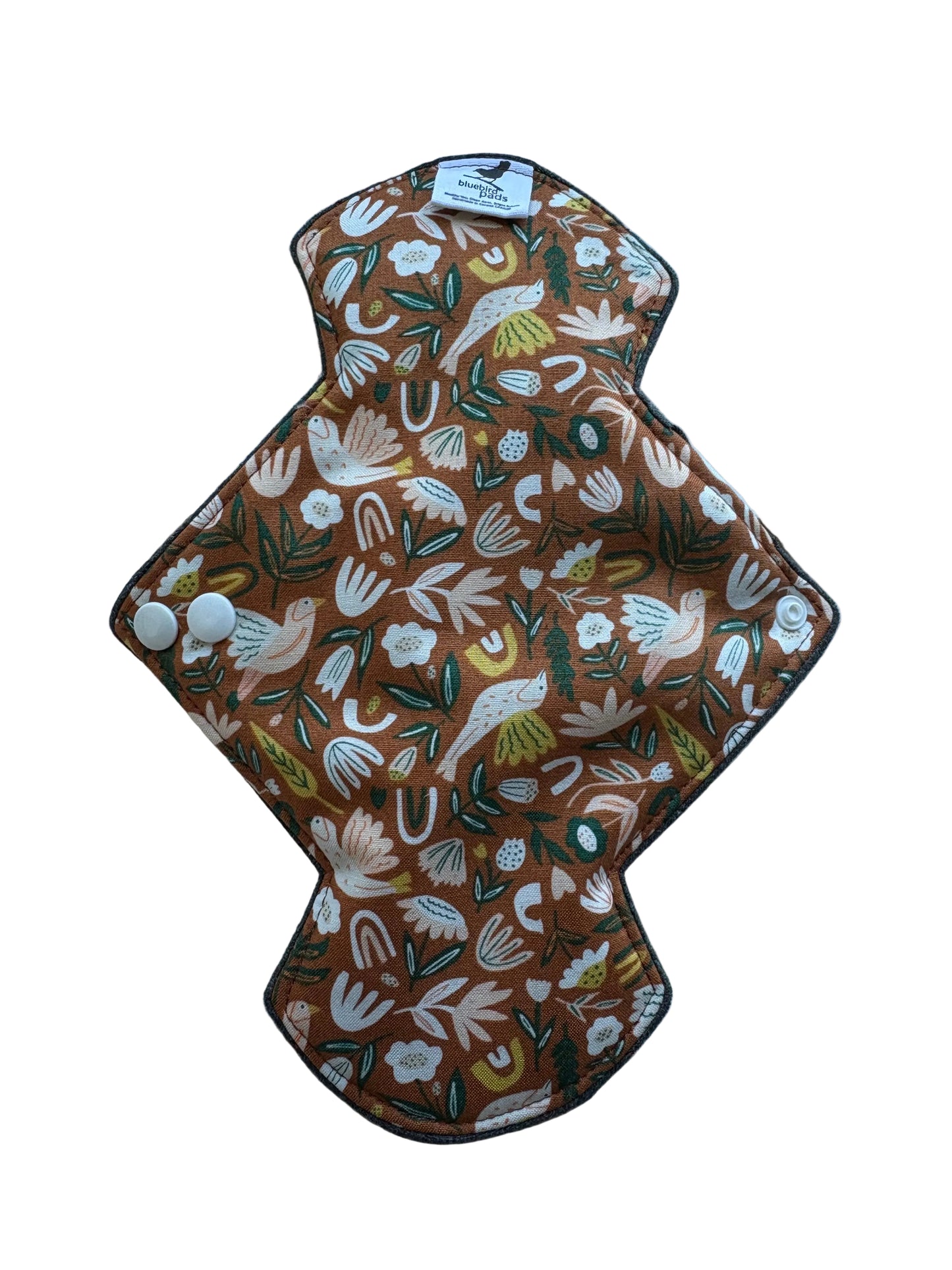 Heavy Flow Day Pad Decorative wall hanging with floral pattern on a plain background
