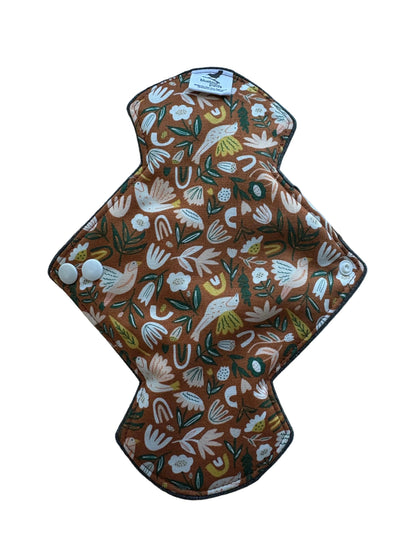 Heavy Flow Day Pad Decorative wall hanging with floral pattern on a plain background
